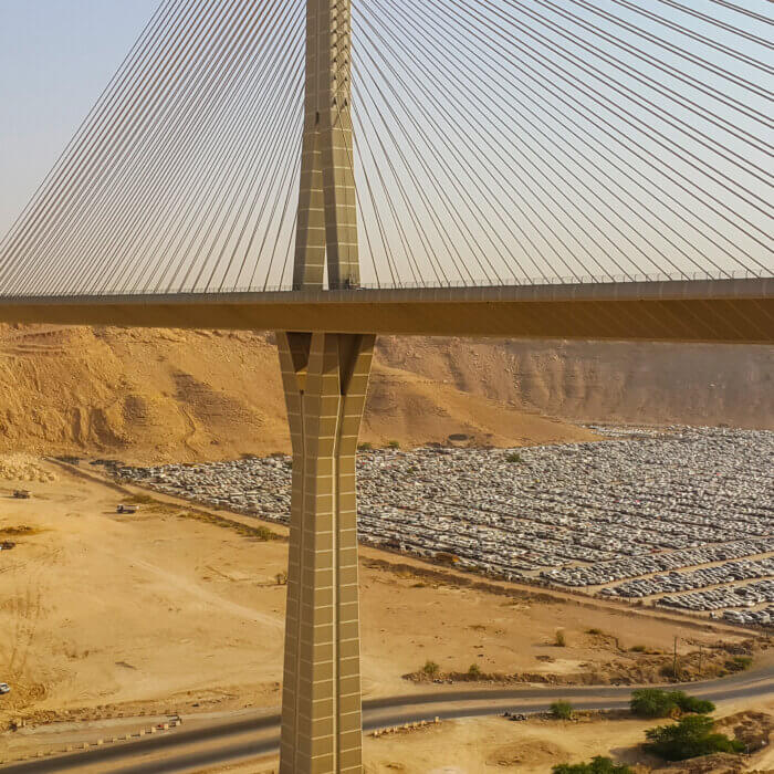 View of city in mountains below suspension bridge in Saudi Arabia
