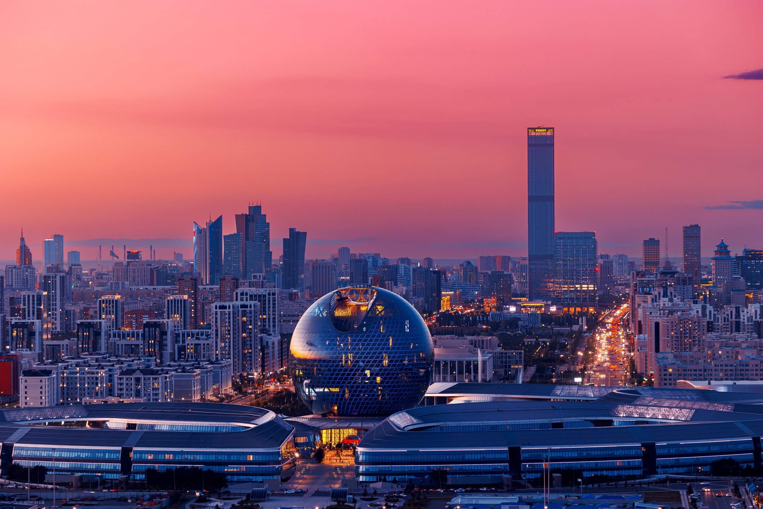 Image shows buildings in Astana, Kazakhstan at sunset